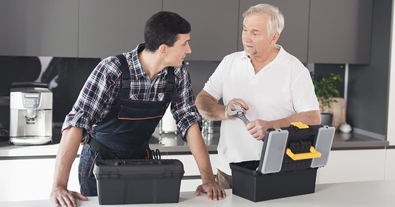 Two plumbers discuss tools