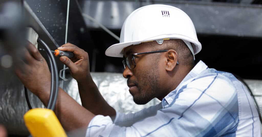 male electrician fixing panel