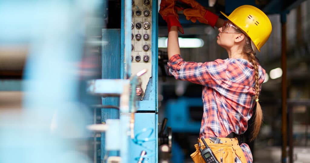 woman fixing electrical panel